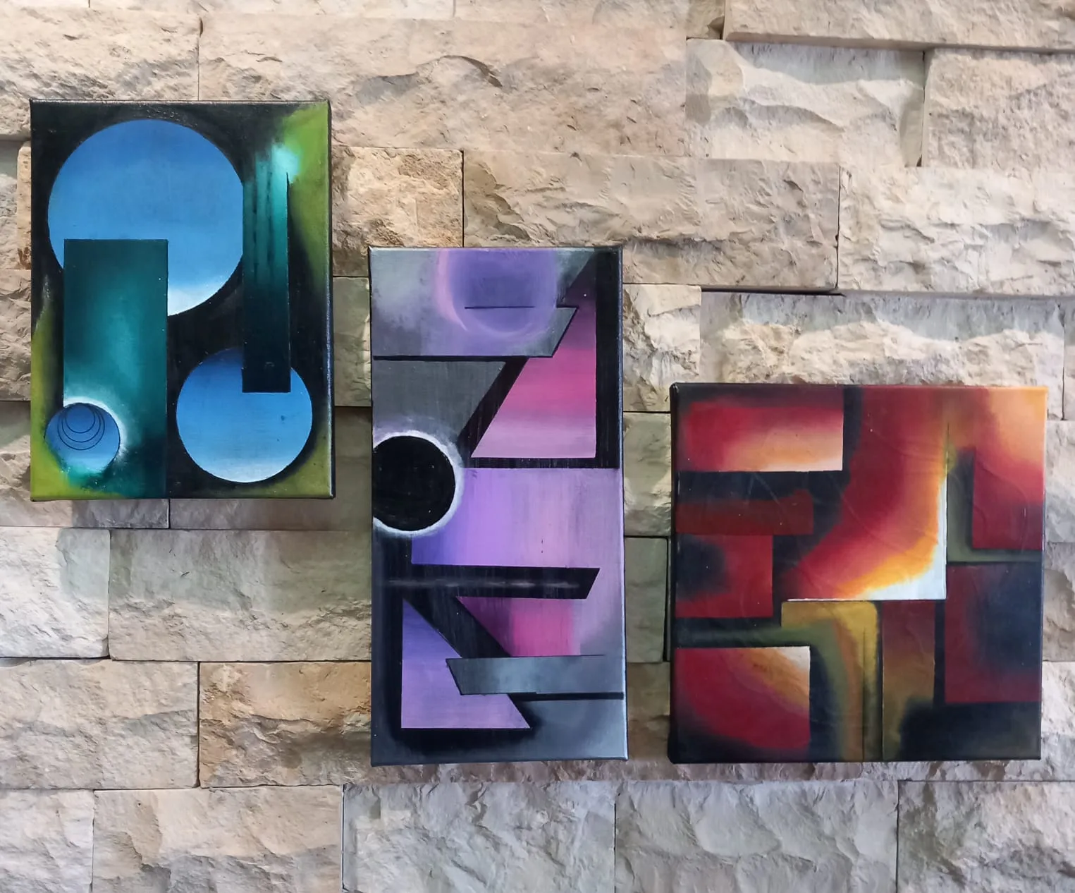 Three panels of coloured geometric shapes