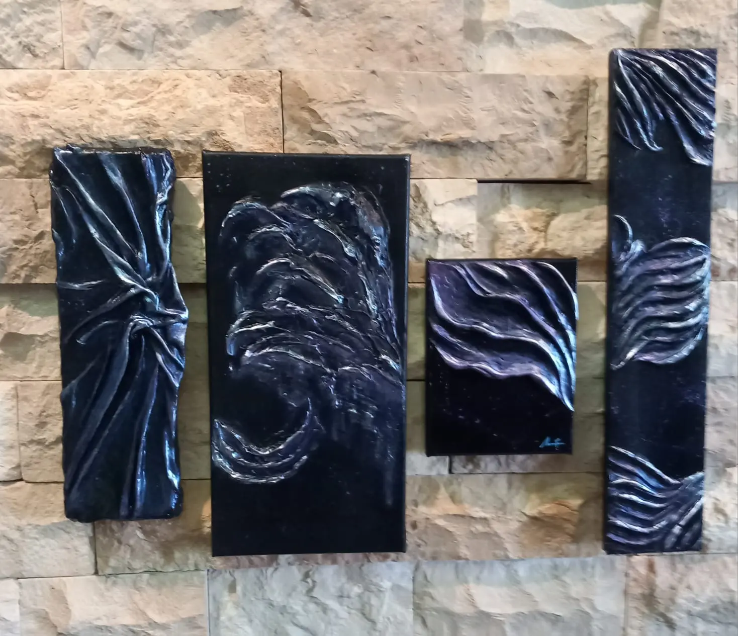 Four black panels with silver textured waves